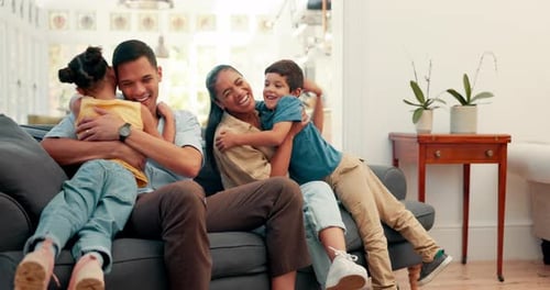 Happy Family Hugging on the Couch at Home