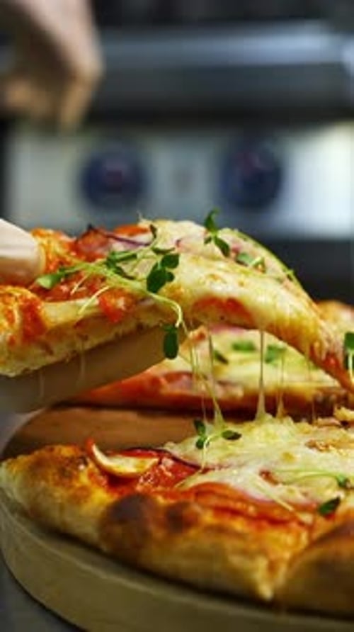 Cheesy Pizza Slice Being Lifted, Close Up