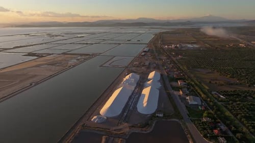 Aerial view of salt pans and factory at sunset, Greece.