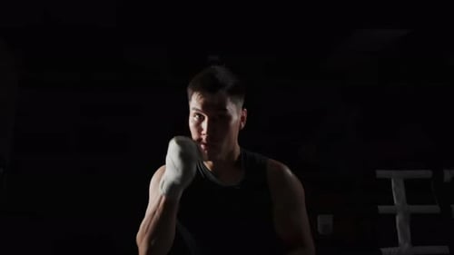 Workout in the Gym A Man Punches to the Sides of the Camera Slow Motion
