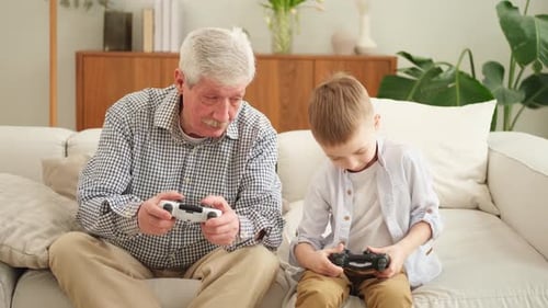 Grandfather and Grandson Playing Video Games at Home