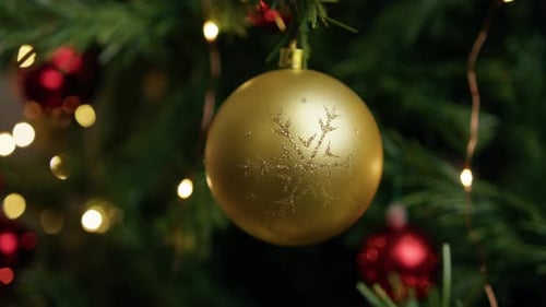 Festive Gold Bauble on Christmas Tree Close Up