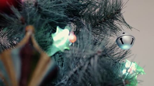 Christmas Ball, Ornaments, And Lights Hanged On Artificial Pine Tree. - close up