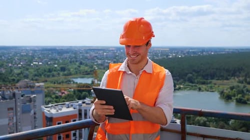 Engineer Working on Tablet Outdoors on Rooftop