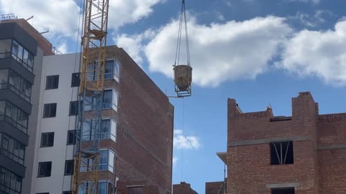 Construction Crane Delivers Mortar To Builders