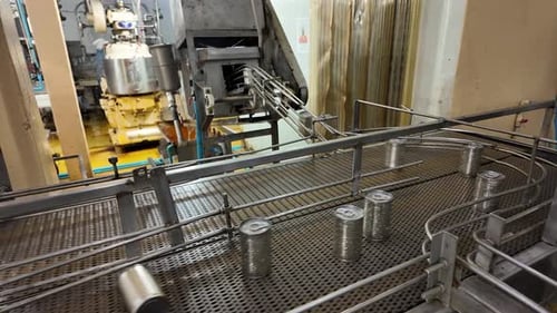 Cans Moving on Conveyor Belt in Factory