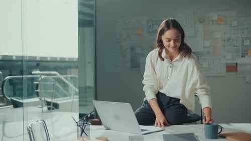 Young Female Architect Is Hard at Work in Her Office on Blueprints and Projects