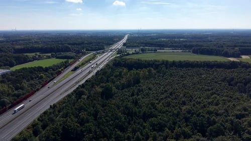 Traffic on American highway in rural forest area at sunny day. Autumn Season with cars and trucks