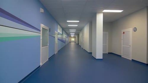 School Corridor Painted in Soft Blue Colour Illuminated By LED Lamps