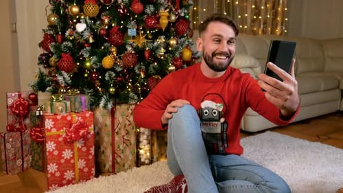 Smiling Man Video Calling Near Christmas Tree