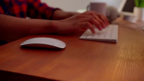 Cropped View of a Man Sitting at a Table and Working at a Computer Male Hands are Typing on the