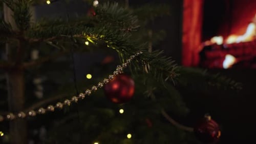 Christmas tree decoration with a TV fire place in the background