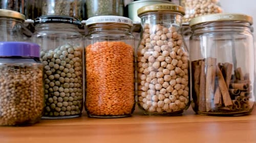 Glass Jars with Chickpeas, Lentils, and Other Food