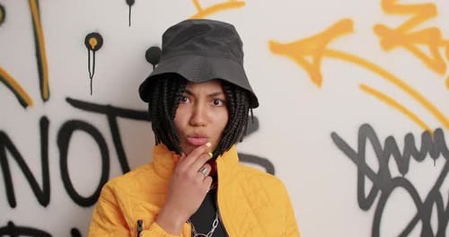 Expressive woman smiling in front of graffiti background