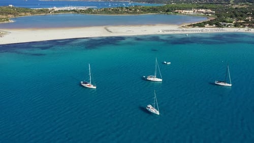 Panoramic view of sandy beach, yachts and sea with azure water, in Villasimius, Sardinia (Sardegna)