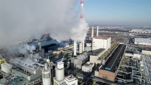 Aerial view of smoke over a coal-fired thermal power plant in Poland at daylight.
