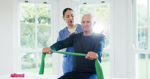 Senior Man Exercising With Healthcare Professional