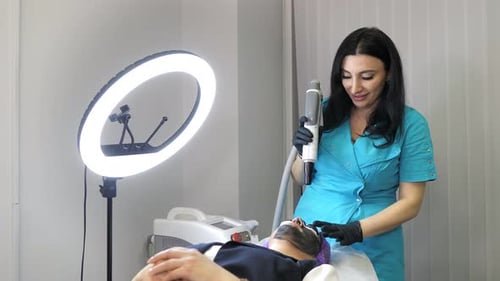Medical Aesthetician Performing Facial Treatment on Patient