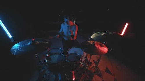 Rock Drummer Playing Drums Energetically on Stage