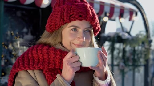 Woman Enjoys Hot Drink at Winter Market