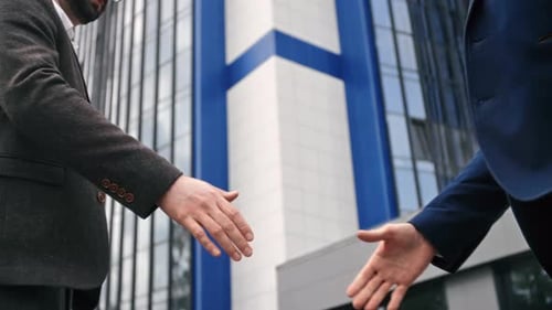 Two Business Man in Suit Greeting Shaking Hands Outdoor Downtown Office District Closeup