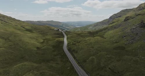 Aerial view of winding road through hills and valley, United Kingdom.