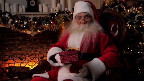 Santa Claus Holding a Present in Decorated Room