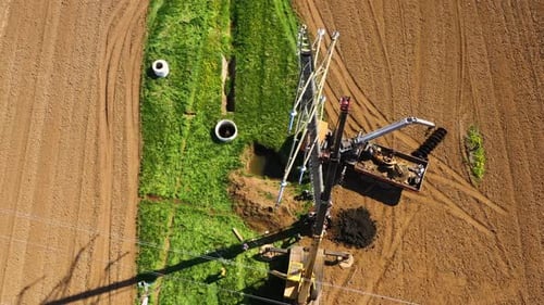 Workers Repairing Electrical Tower in Rural Area