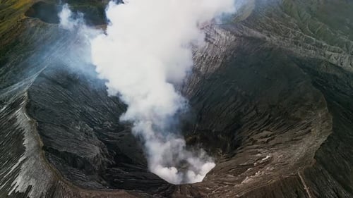 Aerial Drone Footage of Mount Bromo Smoking Crater and Expansive Caldera Terrain in East Java