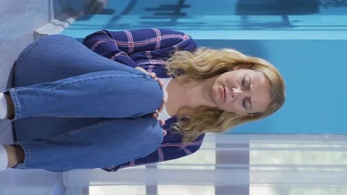 Sad Woman Hugging Knees on Floor Indoors