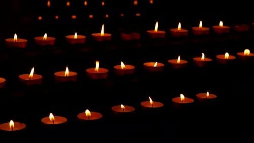 Candles Flickering in Rows in the Dark