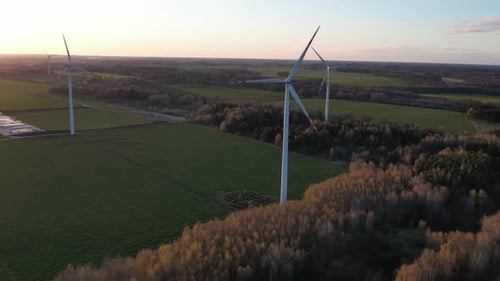 wind turbine farm at sunset, green energy, future electricity, aerial footage.