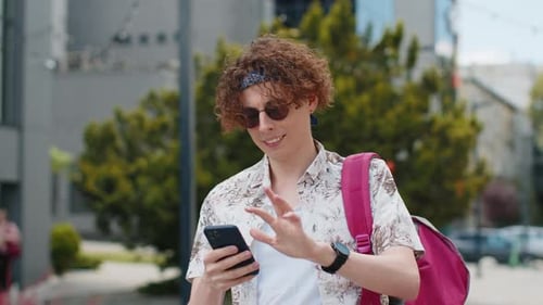 Smiling Young Adult Using Smartphone in Urban Setting