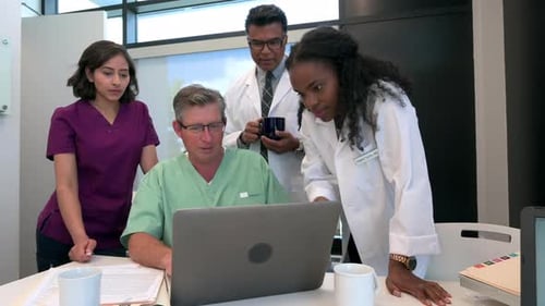 Doctors and Nurses Meeting at Laptop in Clinic 2529 Years