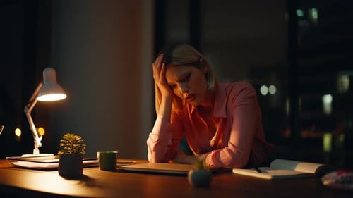 Tired Woman at Her Desk at Night