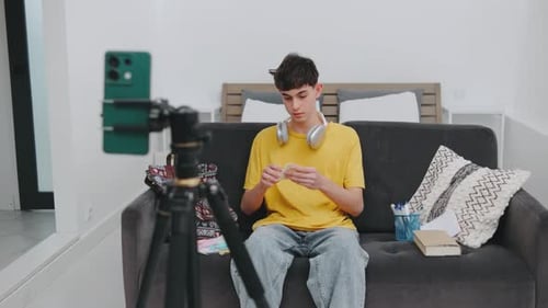 Teen Vlogging with Phone on Tripod in Bedroom