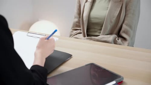 Close up young asian recruiter note during job interview examining with candidate in office.