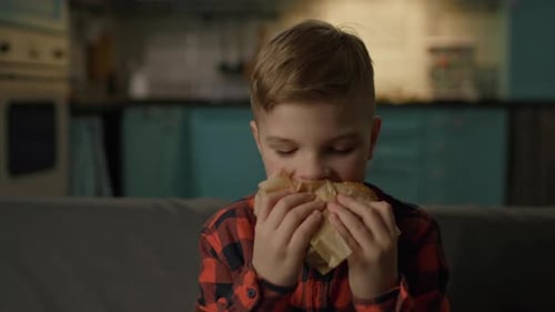 Young Boy Eating Burger with Enthusiasm
