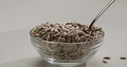 Bowl of Shelled Sunflower Seeds with Spoon