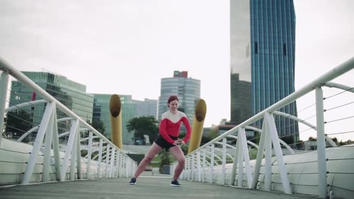 Young Woman Doing Exercise on Bridge Outdoors in City, Stretching