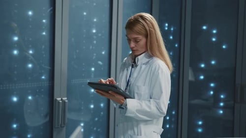 Data Center Couple of Male Female Technologists Checking Server Data in Rack Room Multiethnic