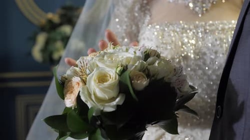 Groom and bride with white roses