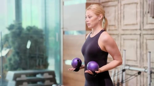 Pilates Workout Process in Modern Studio Blonde Woman Doing Exercise with Weight