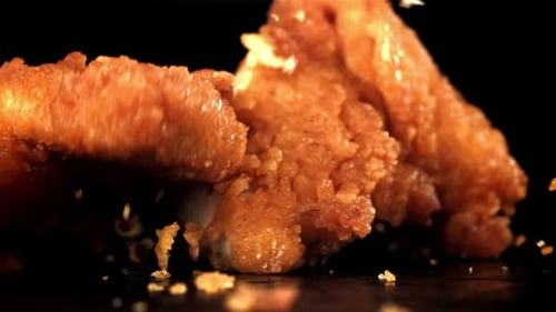 Golden Fried Chicken Tenders Falling into Frame