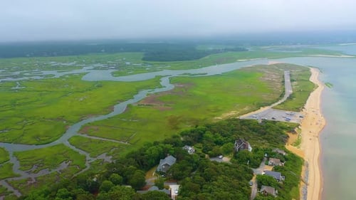 Cloudy Day Drone Video of Beach Houses, Tidal Marsh, and Sandy Shoreline
