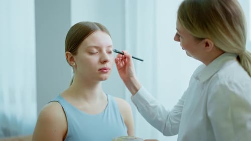 Makeup Artist Work in Her Beauty Studio Portrait of Woman Applying By Professional Make Up Master