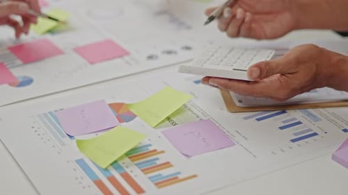 Close up of business hands are working and brainstorming on paperworks.