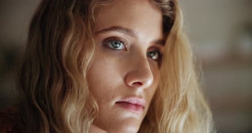 Attractive Blonde Woman Looks Upward in Soft Light