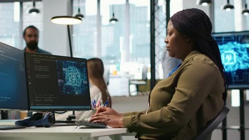 Computer Scientist in Startup Office Reviewing AI System Metrics