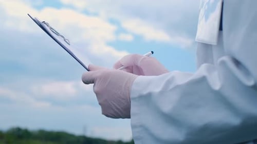 Botanist scientist analyzing plant crop making notes in a journal. Woman gardener biologist testing